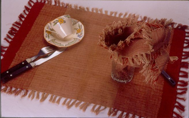 Table mat and napkin (cotton) using traditional texture woven in the Bastar area. Natural dyes; Aal (madder) and Tea leaves.